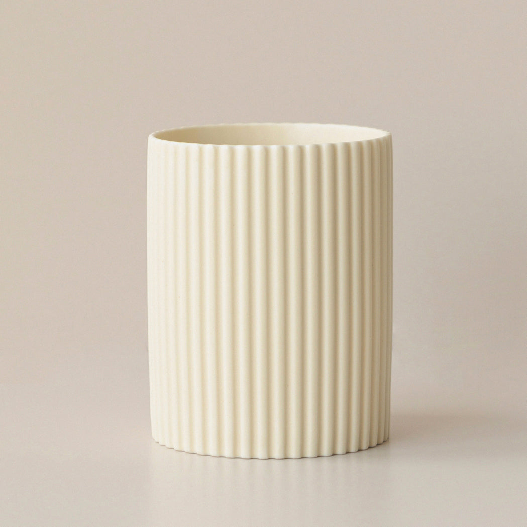 Cream cylindrical pen holder with fine vertical ribbing
